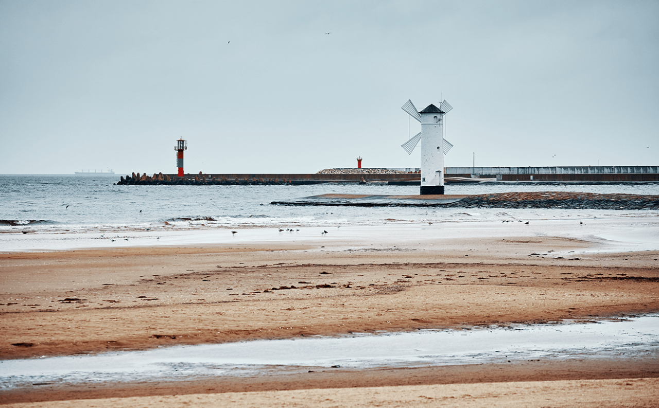 Windmill lighthouse in Swinoujscie on a cloudy day, color toned picture, Poland.